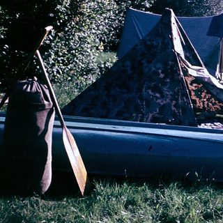 People setting up a tent and preparing for camping.