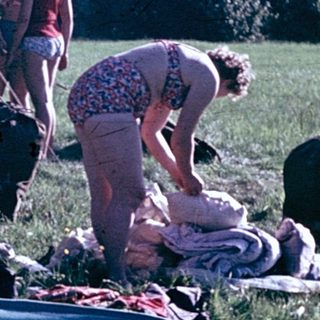 People setting up a tent and preparing for camping.