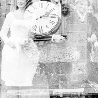 Relief sculpture depicting nurses and doctors with clock.