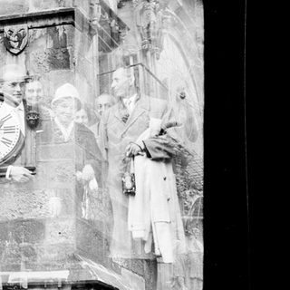 Relief sculpture depicting nurses and doctors with clock.