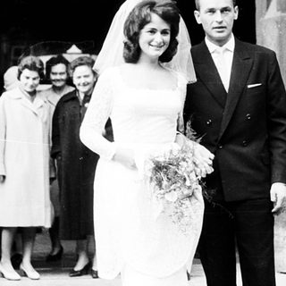 Newlywed couple exiting wedding venue.