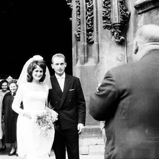 Newlywed couple exiting wedding venue.