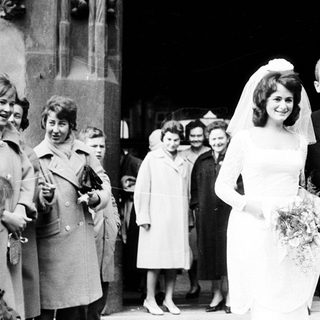 Newlywed couple exiting wedding venue.