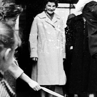 People exiting a building during wartime rationing.