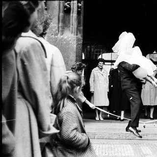 People exiting a building during wartime rationing.