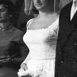Black-and-white wedding ceremony couple exiting venue.