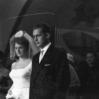 Black-and-white wedding ceremony couple exiting venue.