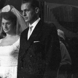 Black-and-white wedding ceremony couple exiting venue.
