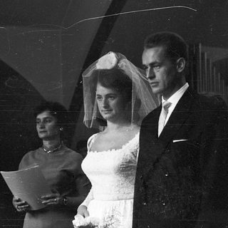 Black-and-white wedding ceremony couple exiting venue.