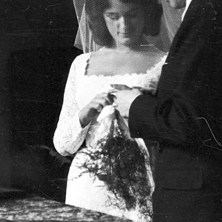 Classic black-and-white wedding portrait with bride and groom.