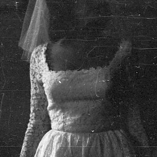 Ethereal bride with veil in dimly lit, starry setting.