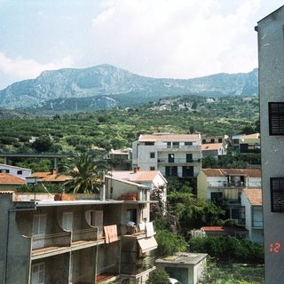 Urban residential area with mountains in background.