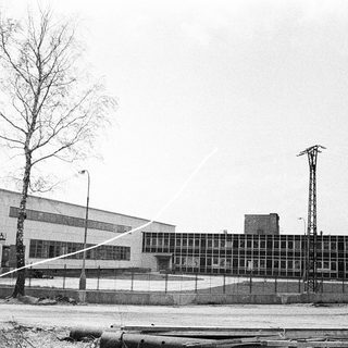 Industrial building complex with large windows.