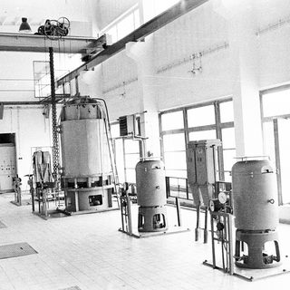 Industrial facility with large pressure vessels and machinery.