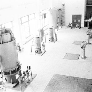 Industrial facility with large cylindrical processing vessels.