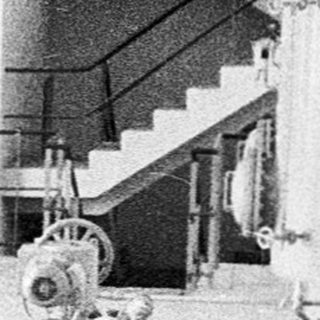 Industrial facility with large processing tanks and machinery.