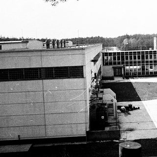 Mid-century institutional building complex with open courtyard.