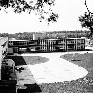 Mid-century institutional building complex with open courtyard.