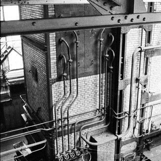 Industrial brewery equipment with copper boilers.
