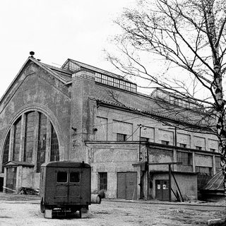 Abandoned industrial building with arched facade.