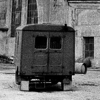 Abandoned industrial building with arched facade.