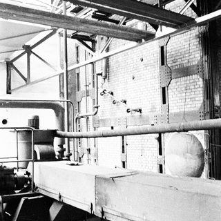 Industrial factory floor with machinery and pipes.