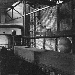 Industrial space with machinery and exposed brick walls.