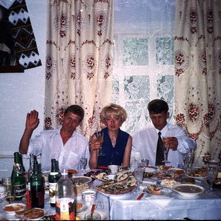 Family gathering celebrating with food and drinks indoors.