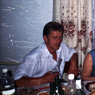 Family gathering enjoying meal indoors.