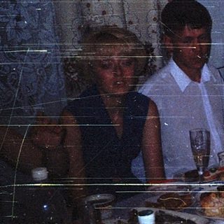 Family celebrating birthday with cake indoors.