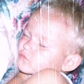Child peacefully sleeping in floral bedding.