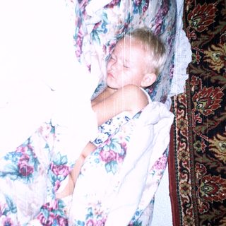 Child peacefully sleeping in floral bedding.