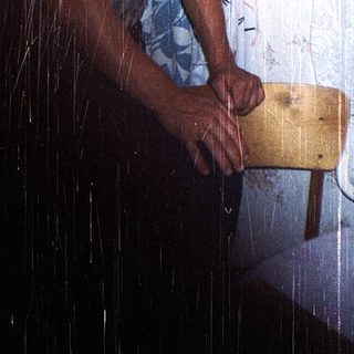 Man standing in shower with rain-like water.