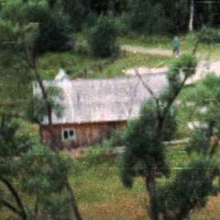 Rural campsite nestled in forested valley.