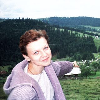 Woman posing in scenic rural forested valley.