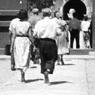Traditional East Asian temple entrance with visitors.