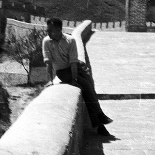 Person sitting on Great Wall parapet.