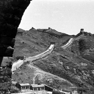Ancient Great Wall winding through rugged mountains.