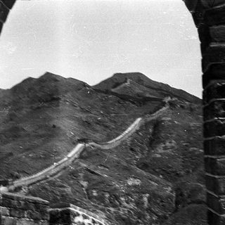 Great Wall winding through rugged mountains.