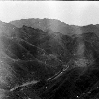 Mountainous terrain with winding road.