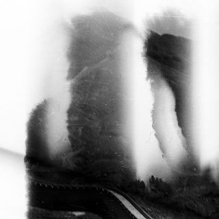 Blurry reflection of people walking outside.