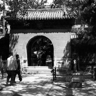 Traditional East Asian temple entrance with visitors.