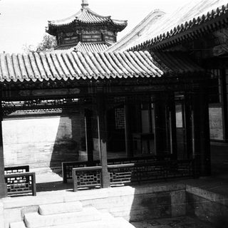 Traditional East Asian courtyard building with tiled roofs.