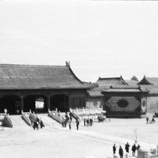 Traditional East Asian palace courtyard with guards.