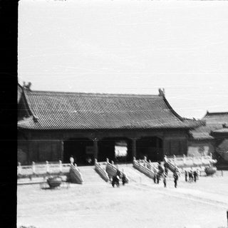 Traditional East Asian palace courtyard with guards.