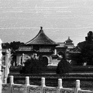 Traditional Chinese pavilion by waterway.