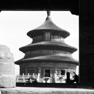Traditional multi-tiered pagoda through window frame.