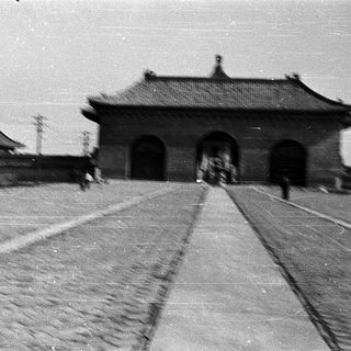 Traditional East Asian gate with tiled roof.