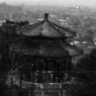 Traditional Chinese pavilion in historical landscape setting.