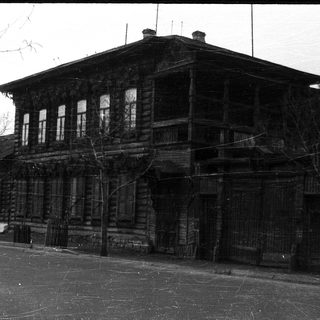 Abandoned wooden two-story building with aged exterior.